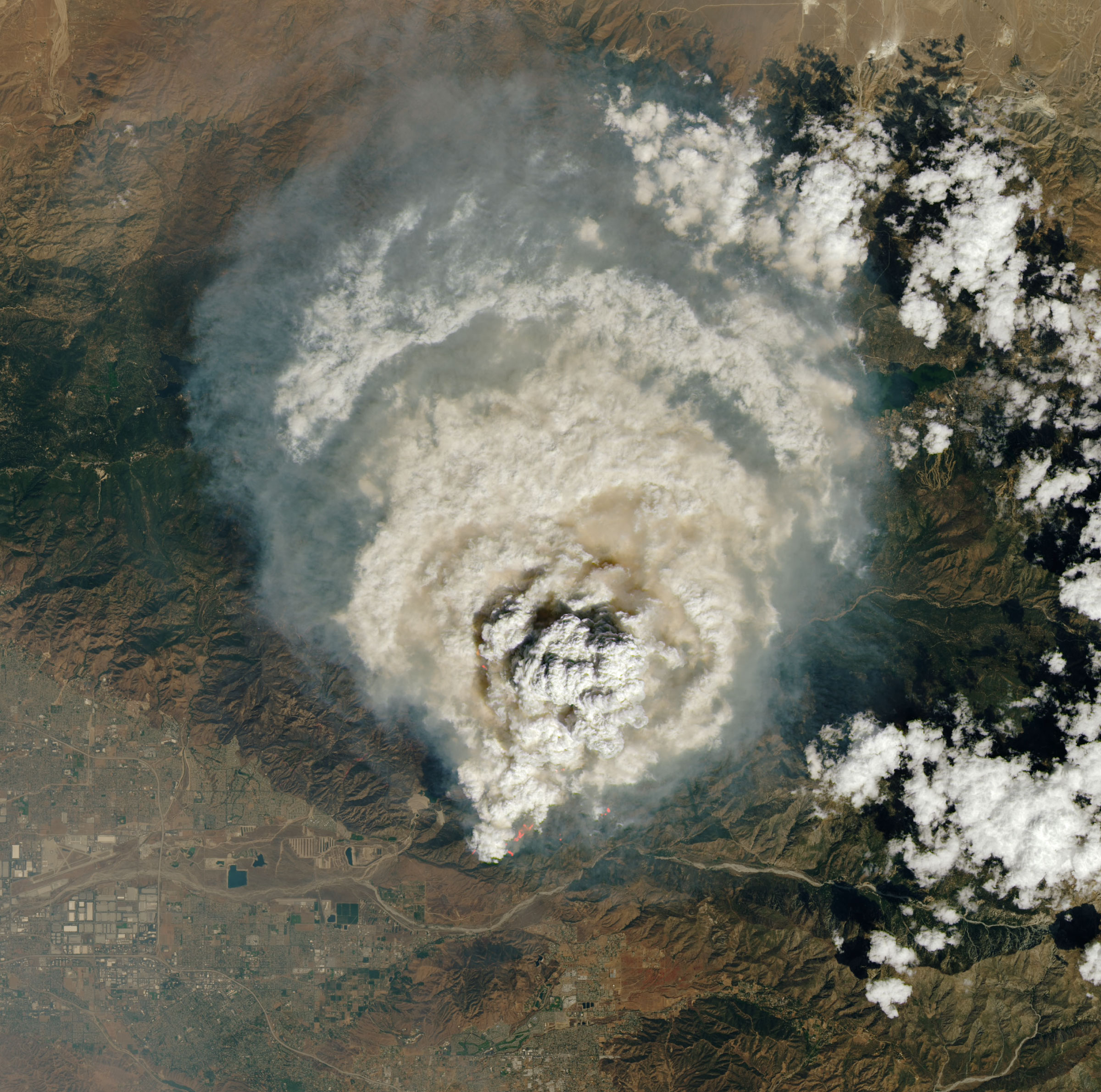 Satellite image shows a large cloud of smoke over Big Bear Lake and Lake Arrowhead, just northeast of San Bernardino and Redlands.